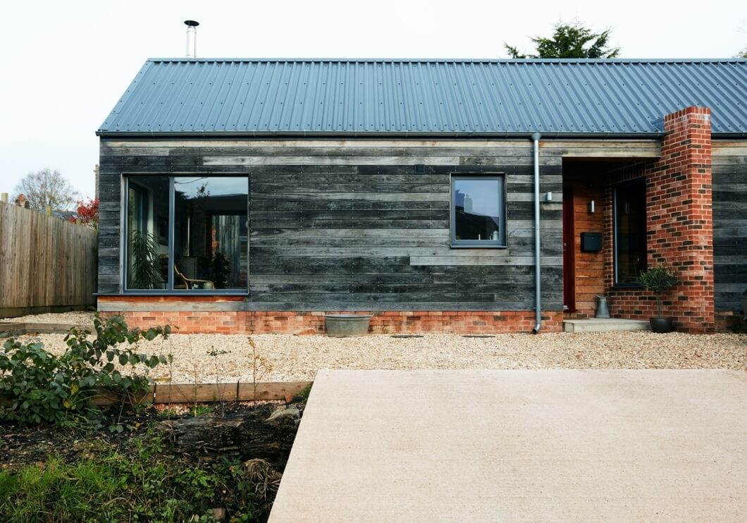 Close-up of Slate Blue Cladco steel roofing sheets on self-build home with Scandinavian design elements