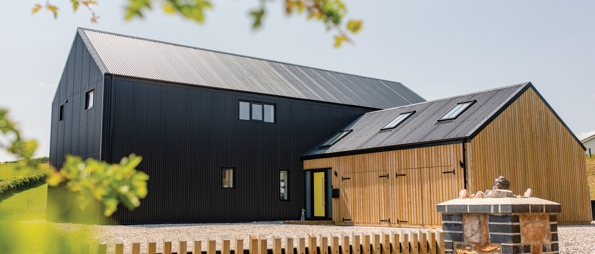 Modern barn-style home featuring black metal roofing sheets