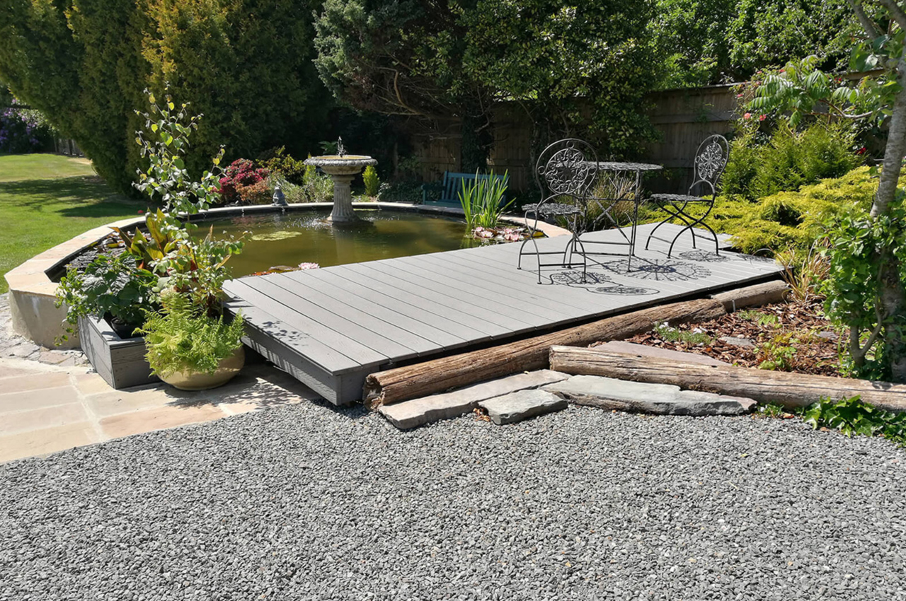 Light Grey Woodgrain Decking by a garden pond and water feature