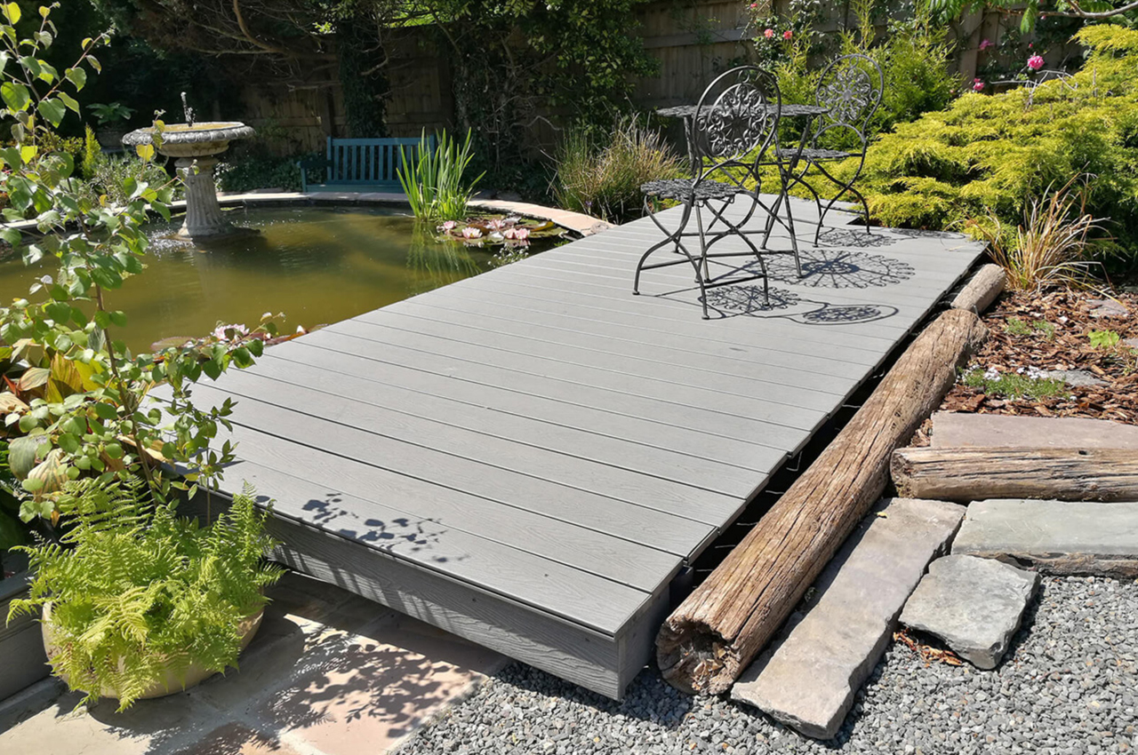 Light Grey Woodgrain Decking by a garden pond and water feature