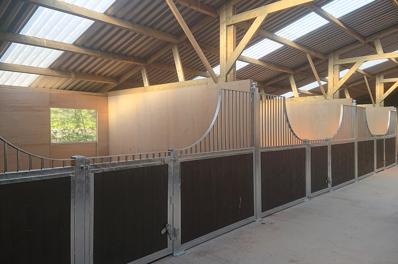 PVC Juniper Green roofing sheets give this stables a modern, yet culturally sound look without impeaching on the surrounding countryside