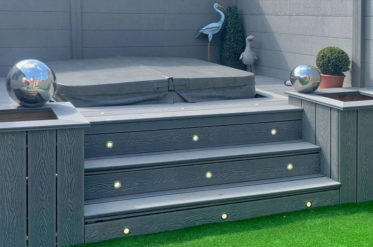 Low-maintenance Composite Fencing and Decking surround a garden hot tub