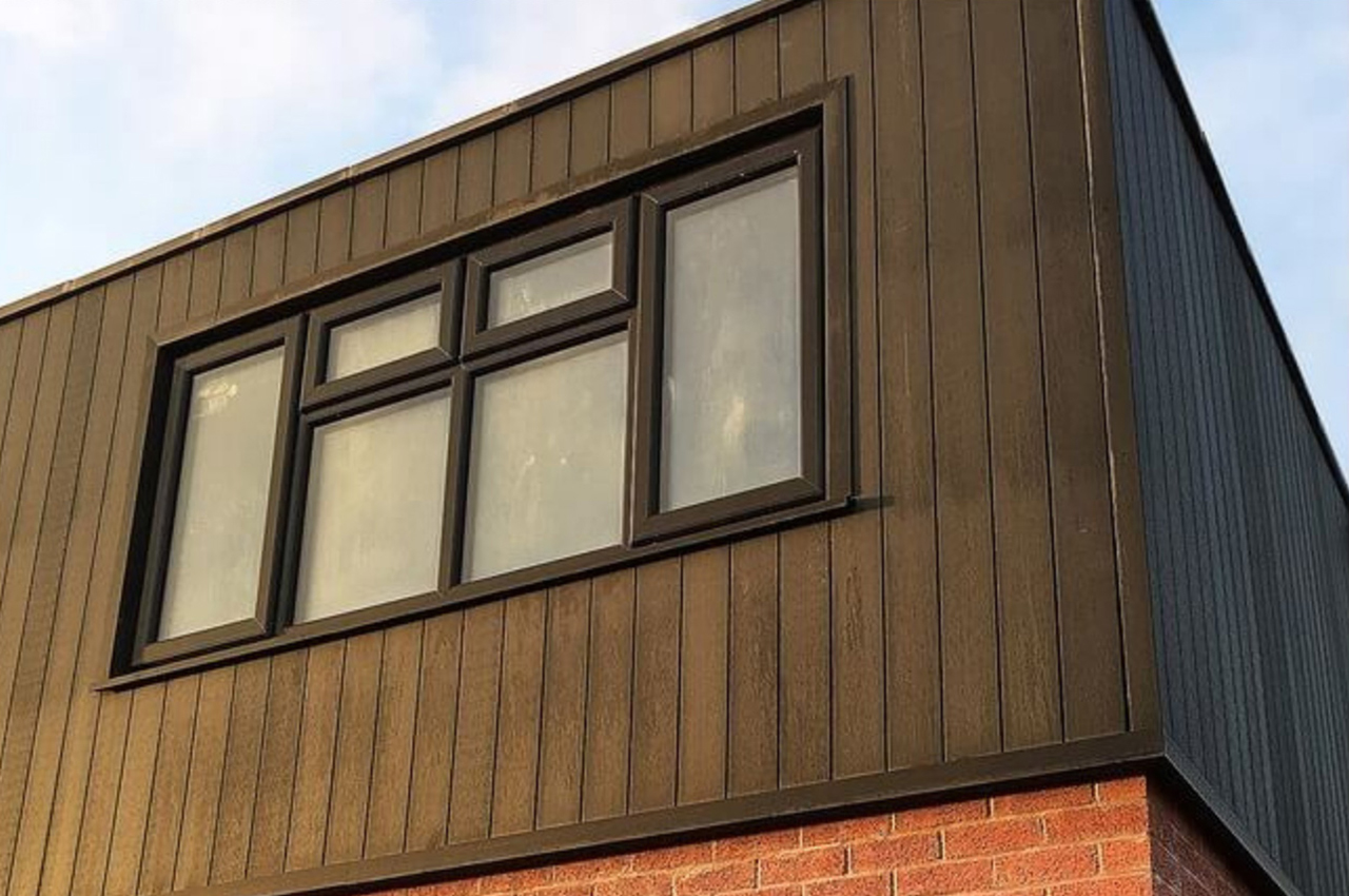 Composite Wall Cladding Boards in Charcoal contrast the existing red bricks on this home exterior