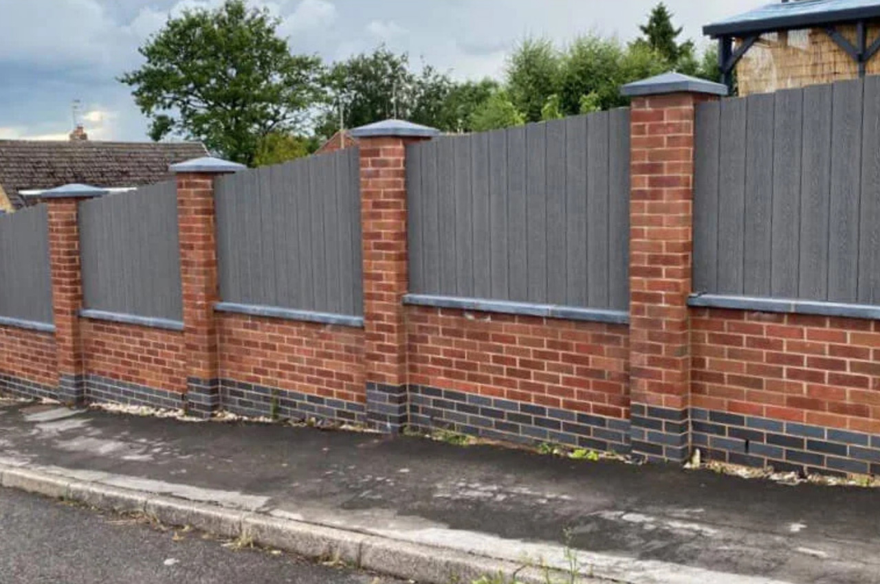 Cladco Woodgrain Composite Decking Boards have been installed as vertical fencing panels around this home