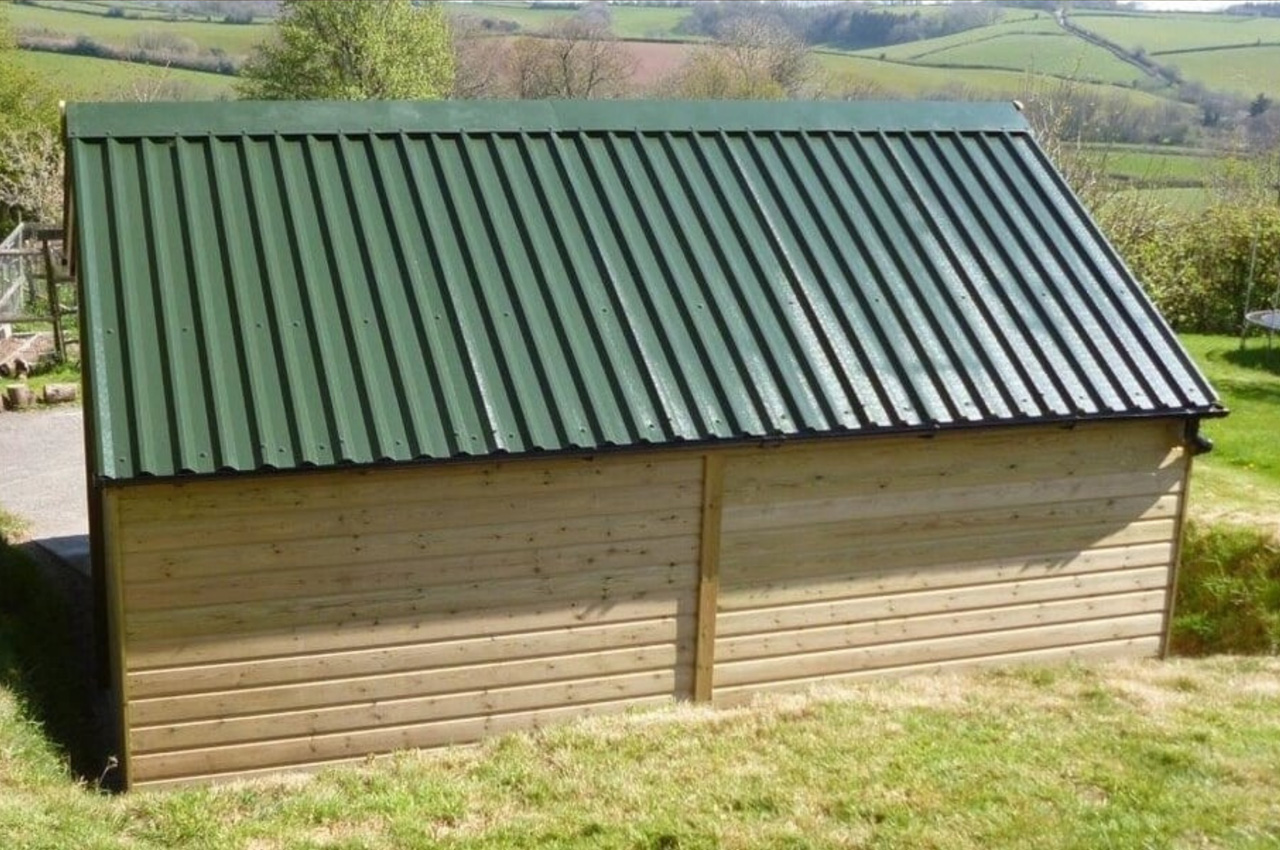 34/1000 Box Profile Roofing Sheets in Juniper Green have helped this roof blend into the surroundings
