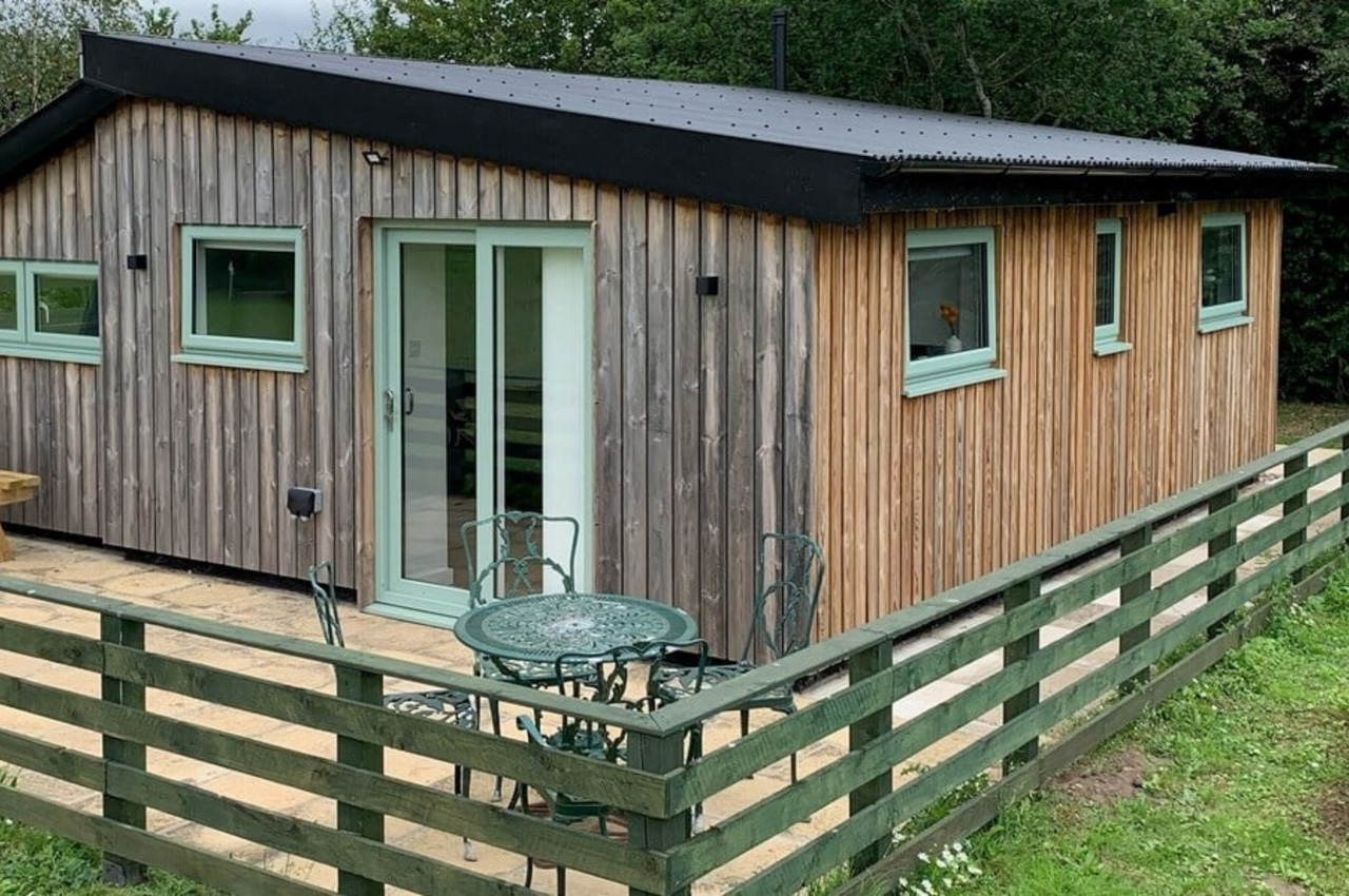 A modern, rustic holiday lodge features Cladco Corrugated Roofing Sheets in Black
