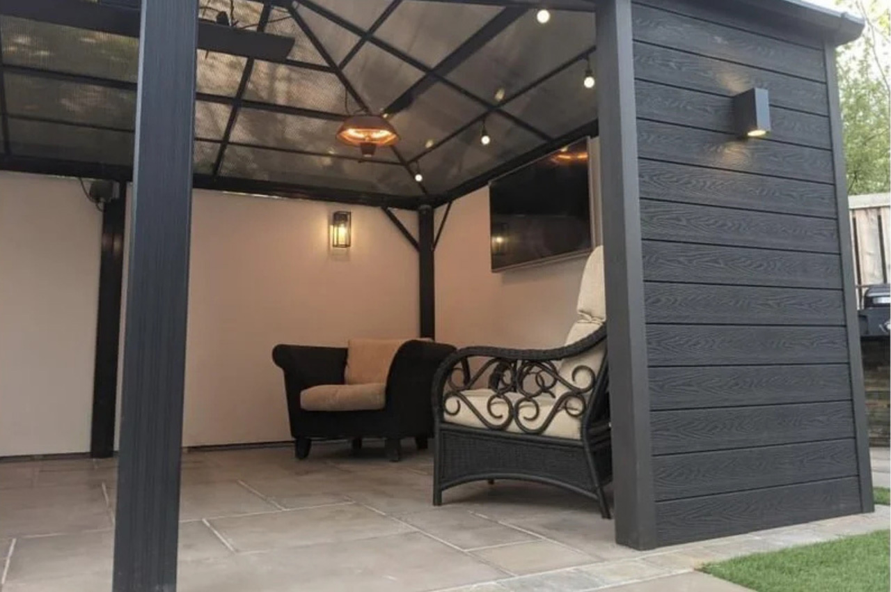 Attractive summer house clad in a sophisticated and contemporary Charcoal Woodgrain Composite Wall Cladding