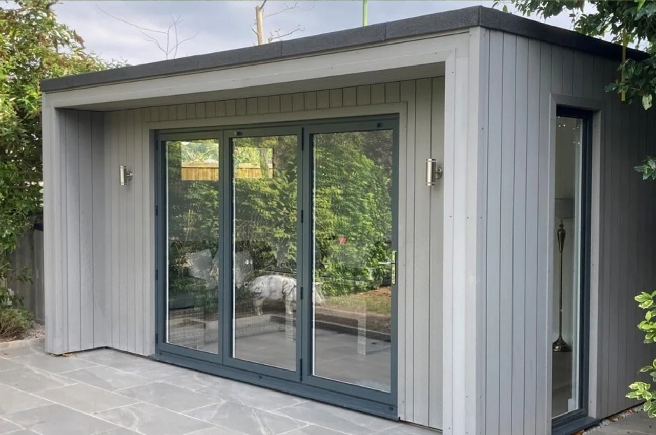 Vertical Composite Wall Cladding in Light Grey features on the exterior of this large garden room