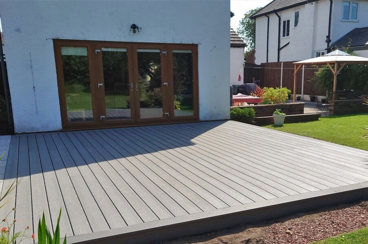 Cladco Woodgrain Composite Decking in Light Grey in this sunny garden location