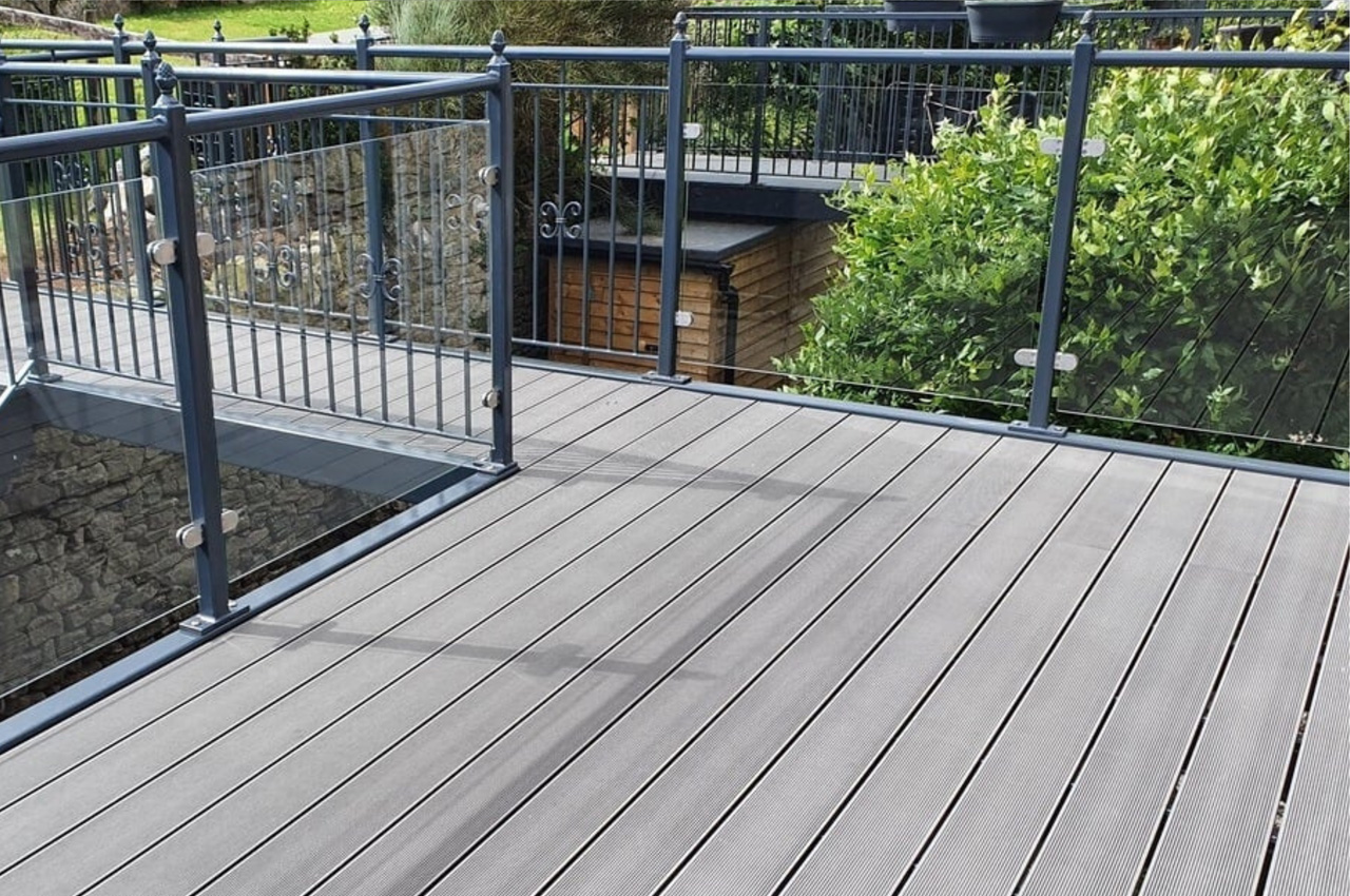 Stone Grey Raised Decking encircles this traditional stone wall cottage.