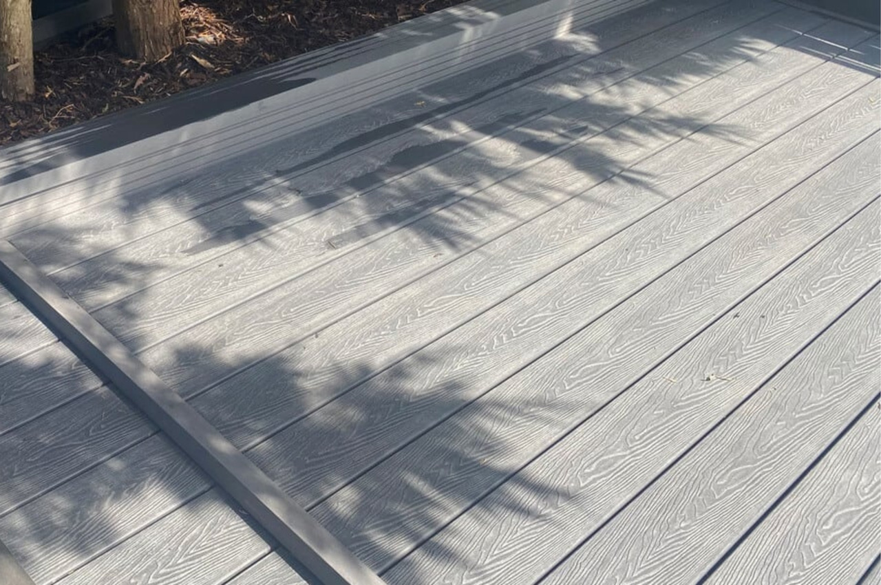 Cladco Composite Woodgrain Boards in Stone Grey make for a relaxing, raised decking in this garden