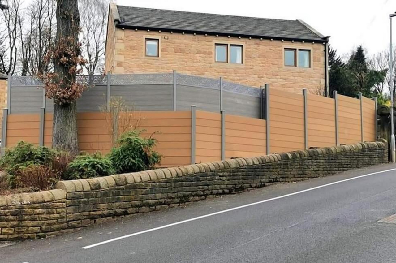 This homeowner selected Cladco Composite Fencing Panels in Teak with Stone Grey Posts 