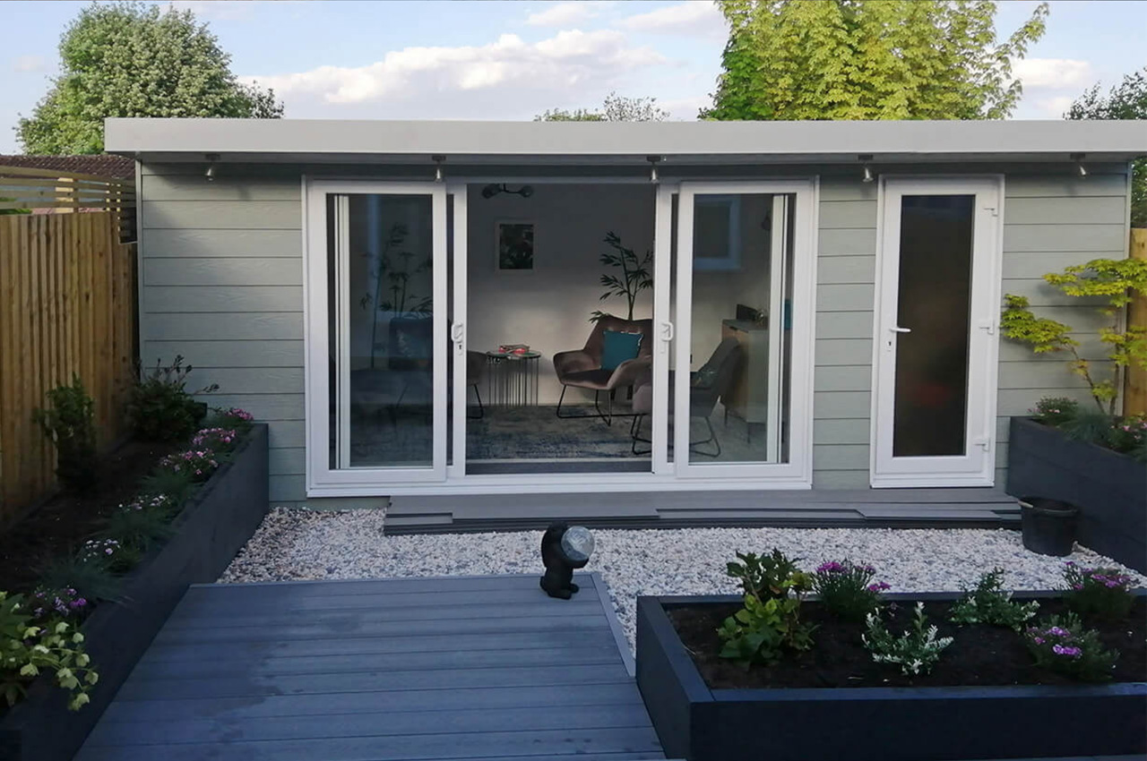 Sage Green Fibre Cement Wall Cladding Boards protect this cosy garden room