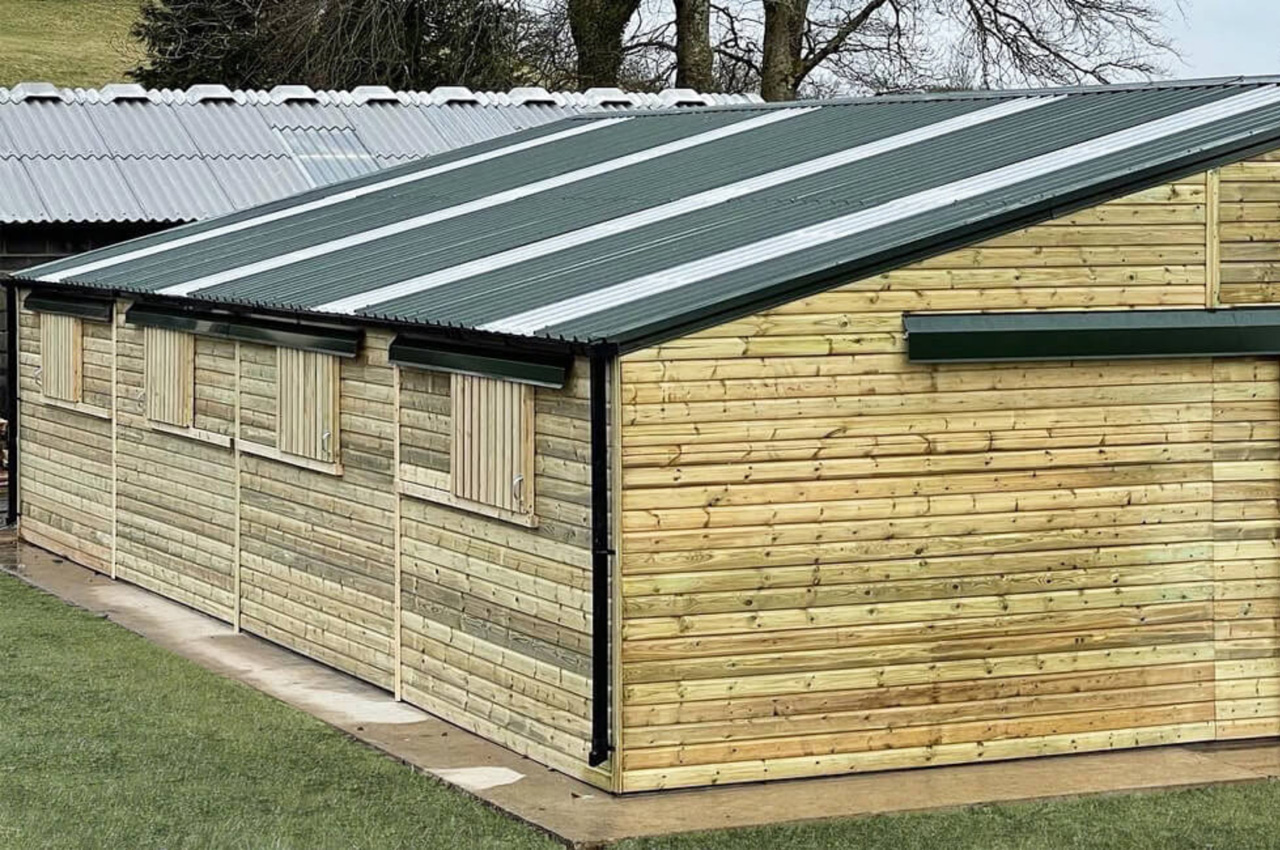 Large barn design by @devonshire_stables using Cladco 32/1000 Roofing Sheets in Juniper Green
