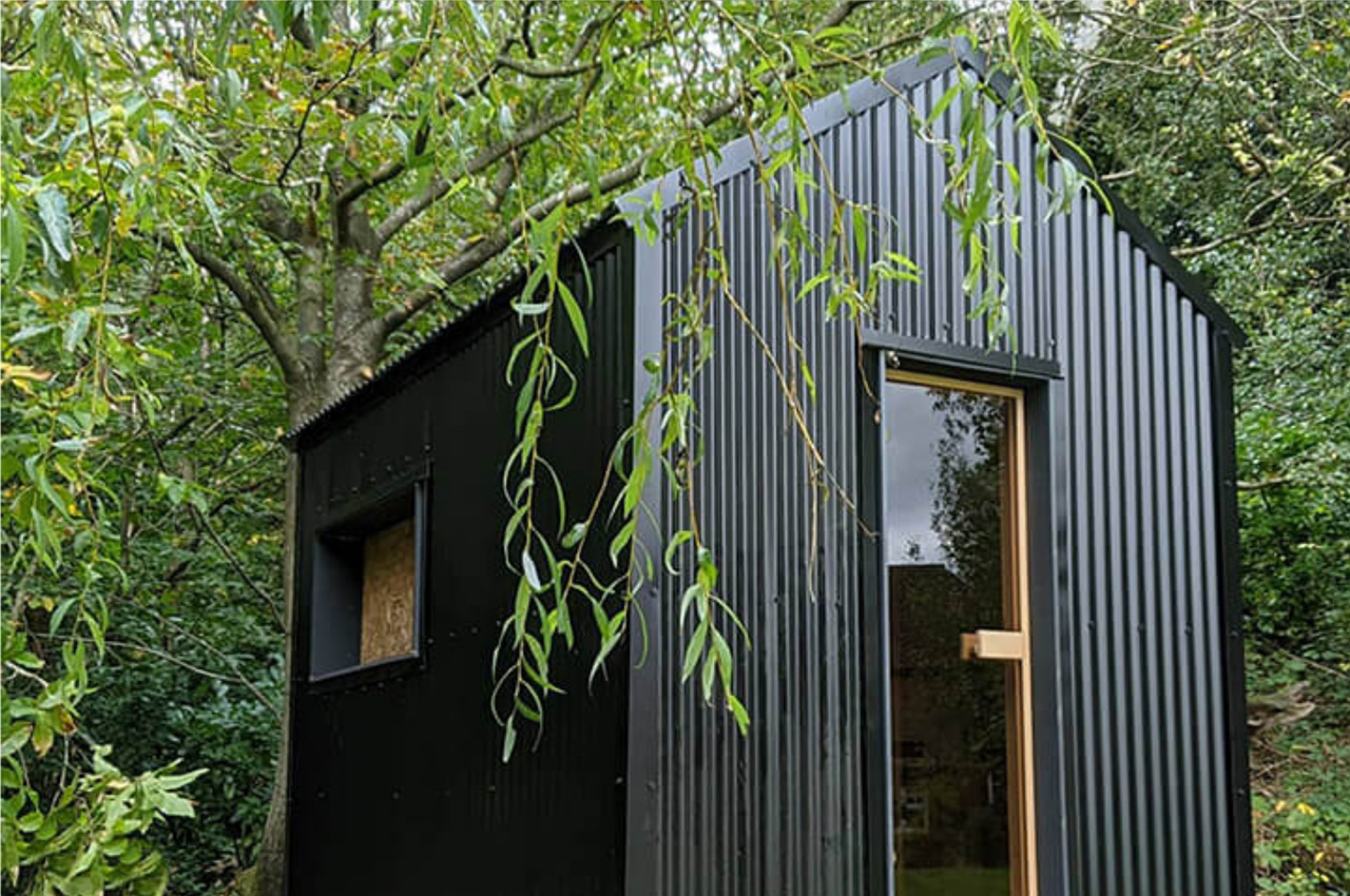 Black Corrugated Cladding Sheets adorn this garden sauna
