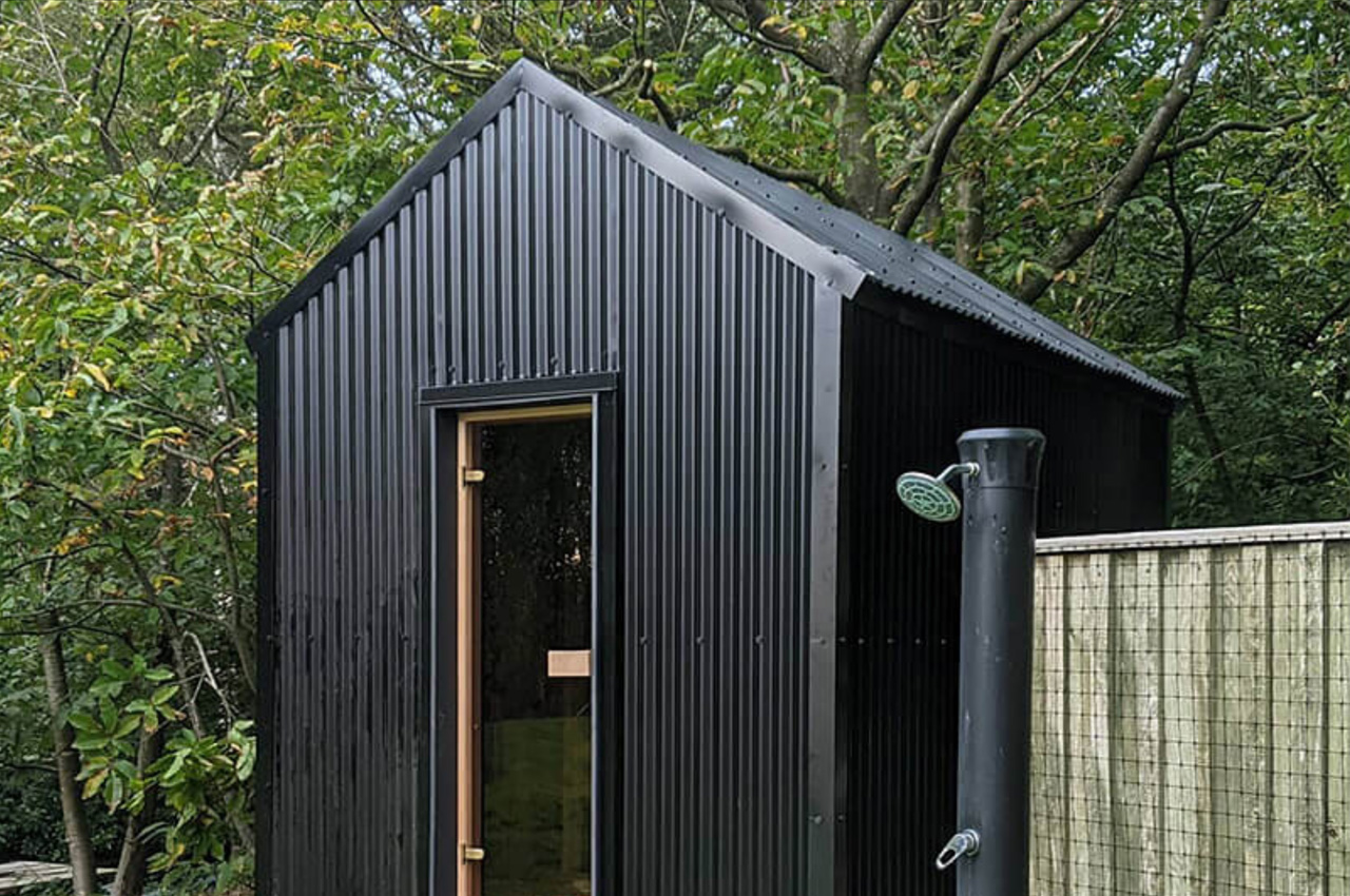 Black Corrugated Cladding Sheets adorn this garden sauna