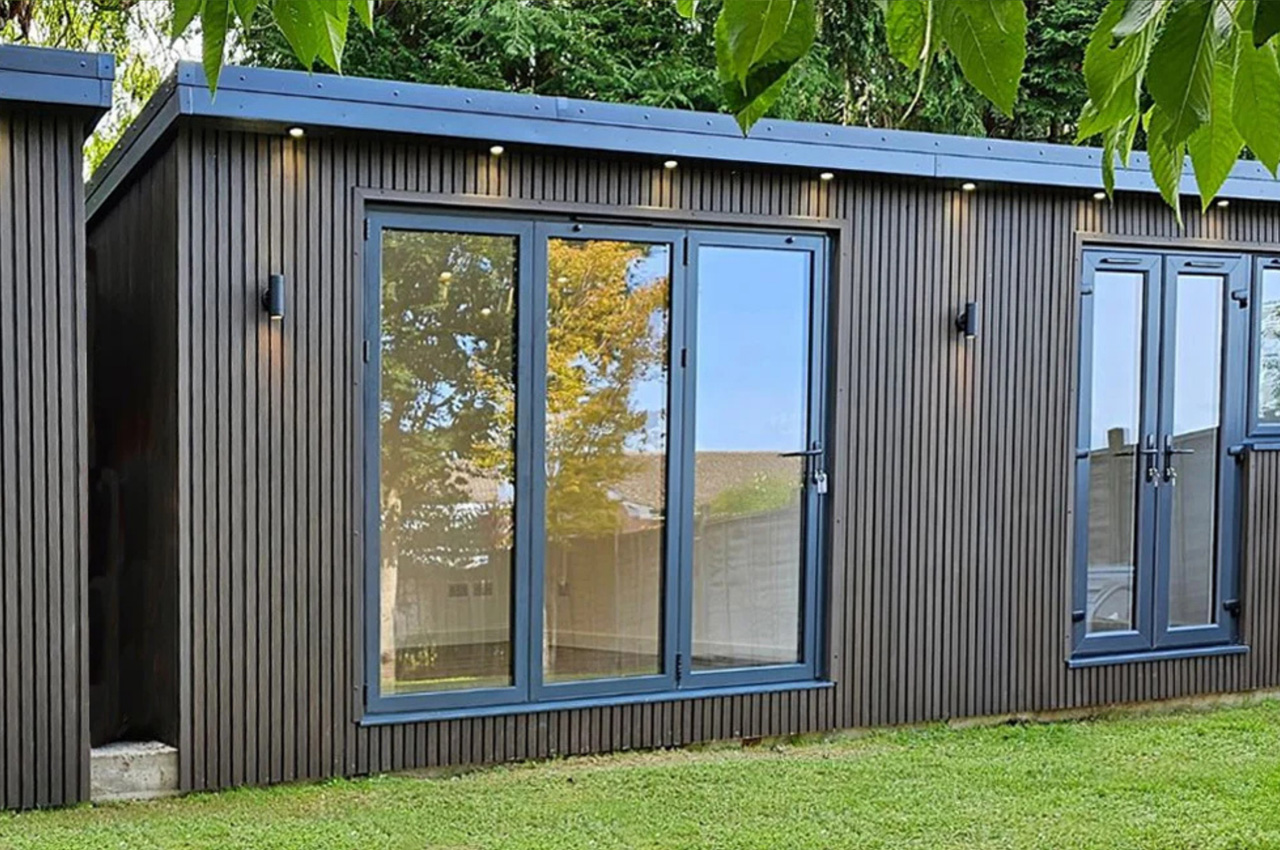 Cladco Composite Slatted Wall Panels in Walnut encase this versatile garden room.