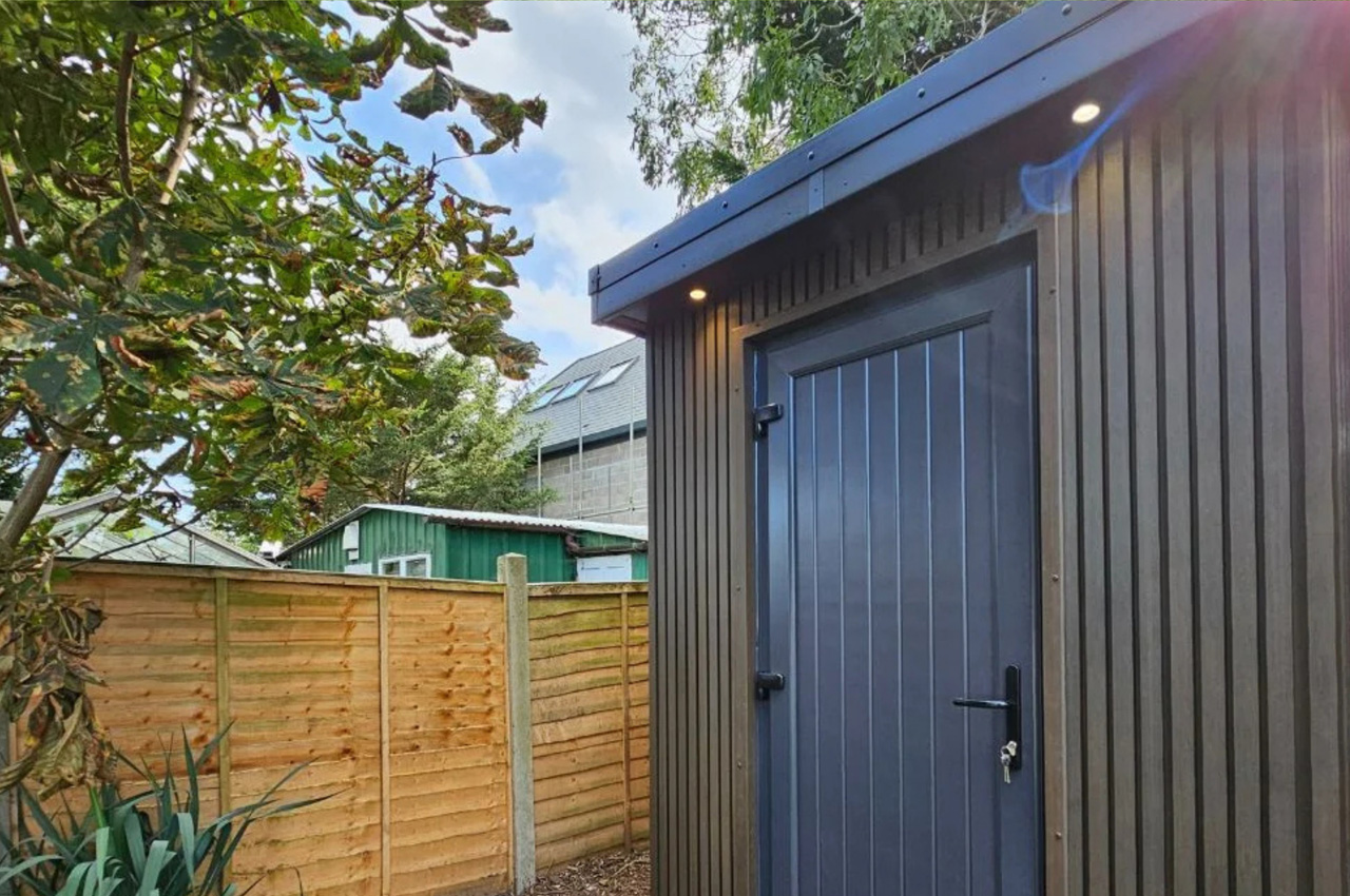Cladco Composite Slatted Wall Panels in Walnut encase this versatile garden room.