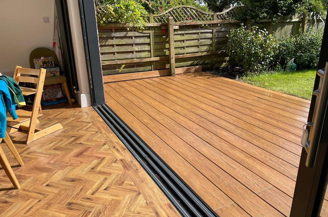 Chestnut Premium PVC Decking area extending from bifold doors onto garden.