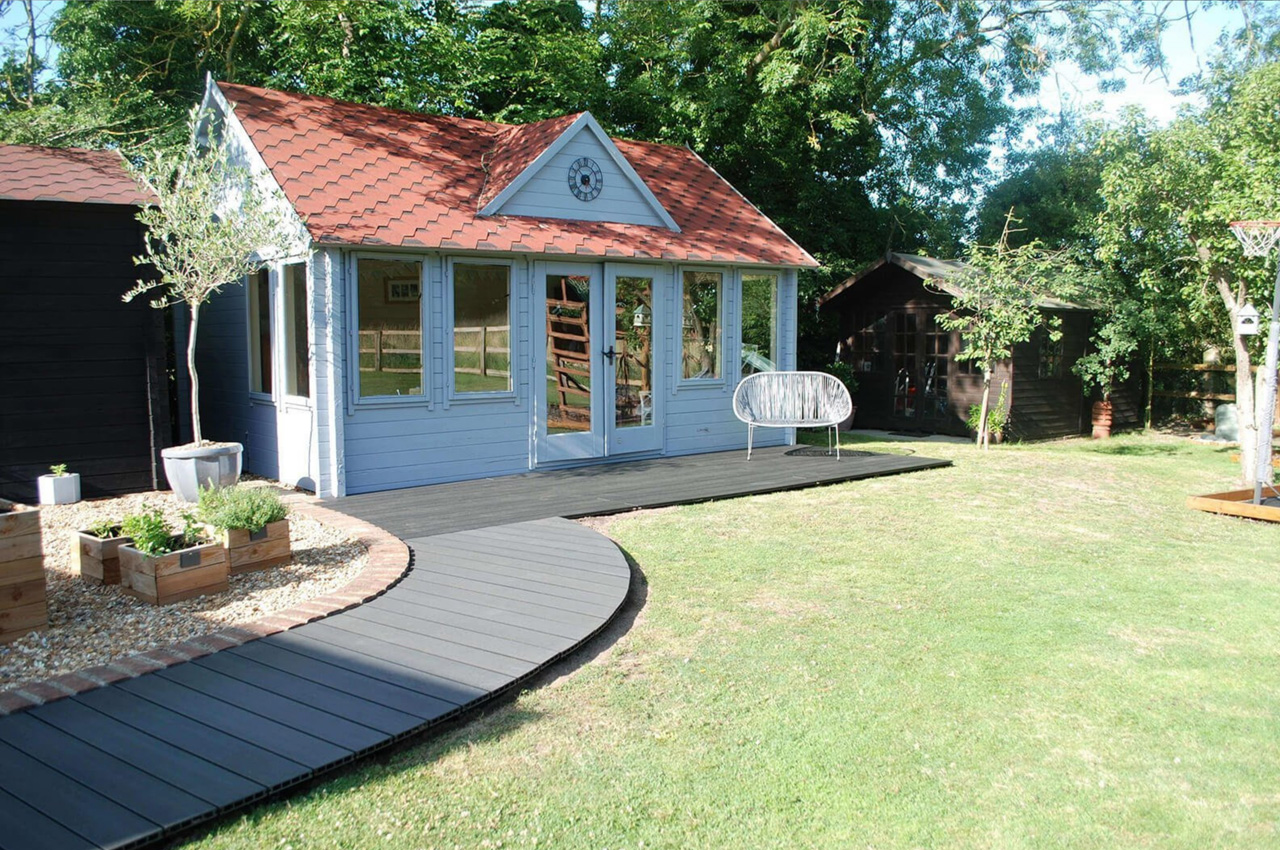 Cladco Composite Decking in Charcoal wraps around a beautiful home