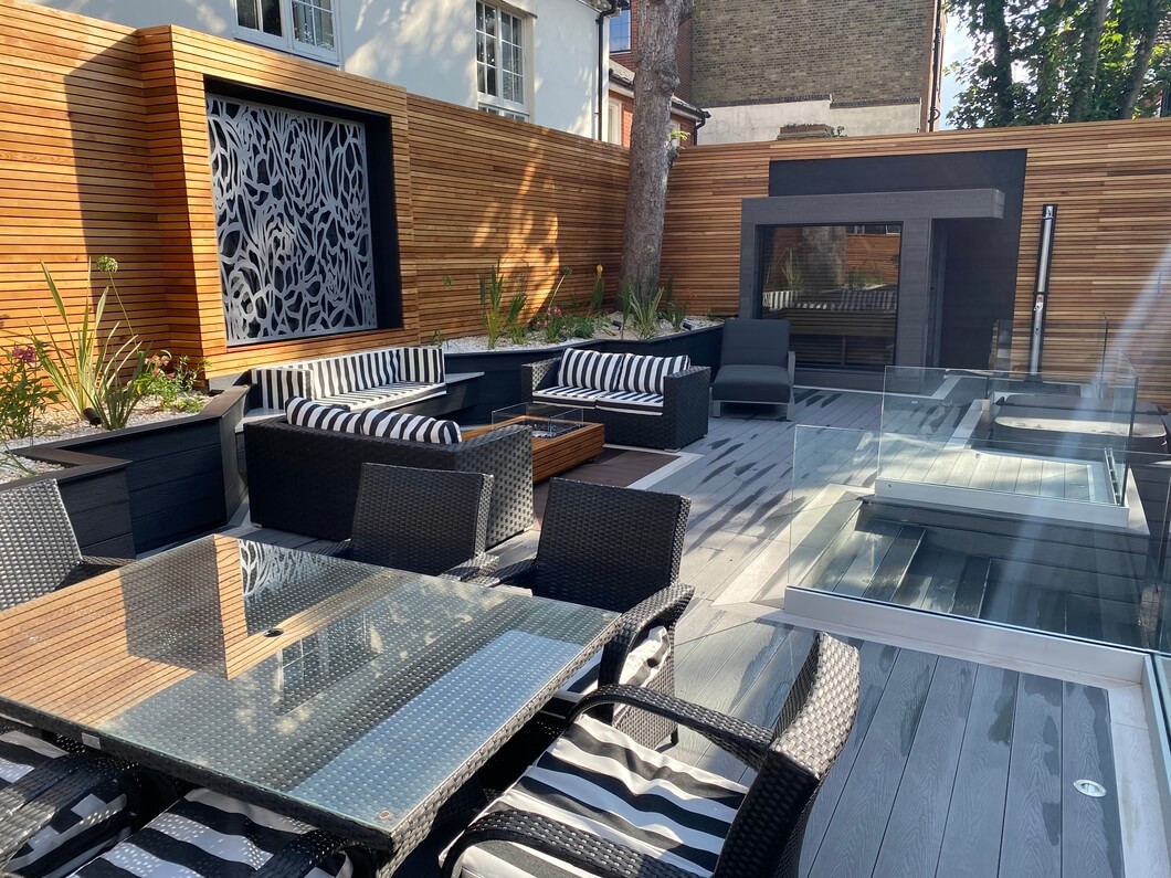 Cladco Stone Grey composite decking with Ivory Bullnose boards creating a picture frame effect in a modern garden setting