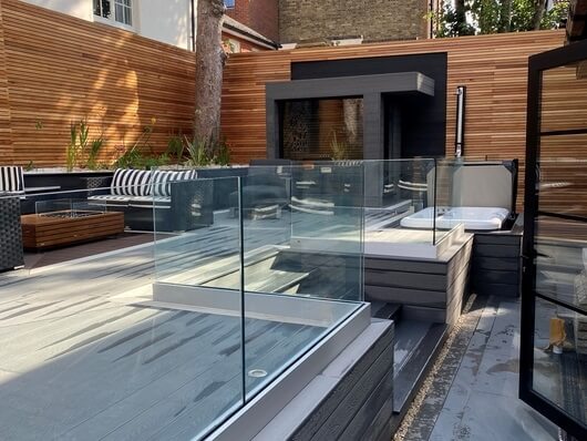 Multi-level garden design utilizing Cladco Stone Grey composite decking boards with fascia detailing to conceal substructure