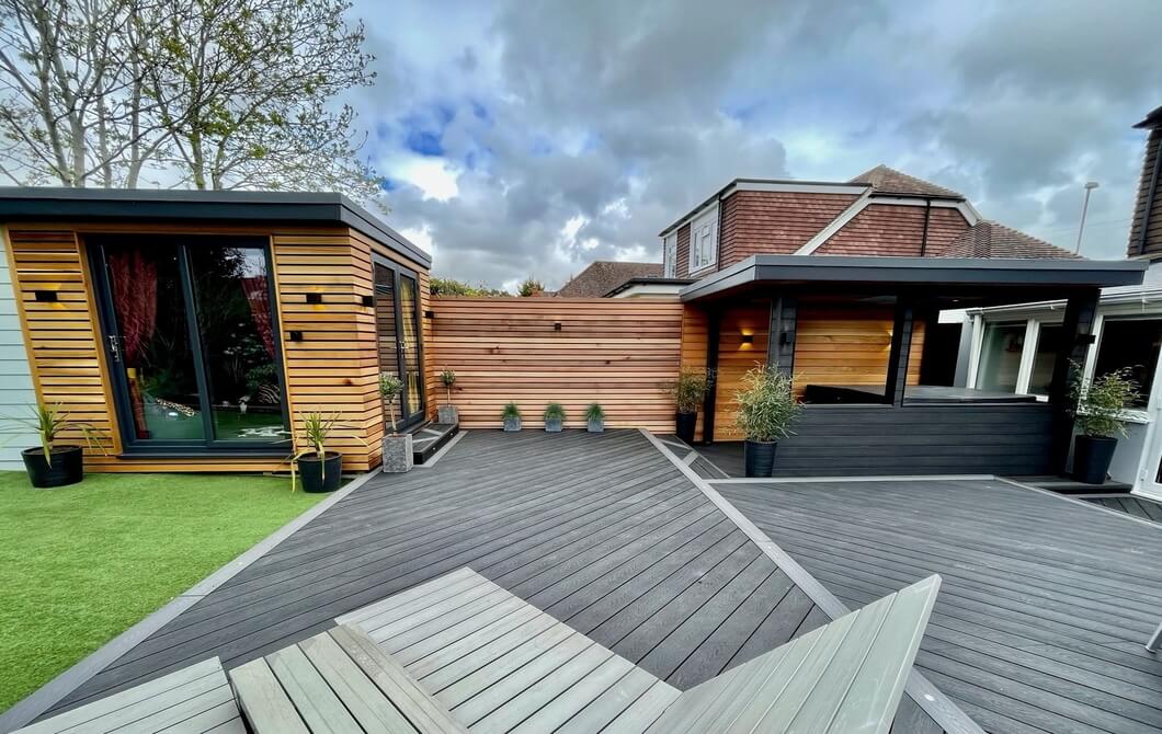 Hot tub pergola area constructed with Cladco Charcoal Composite Decking Boards, providing a seamless indoor-outdoor living space in a modern garden setting