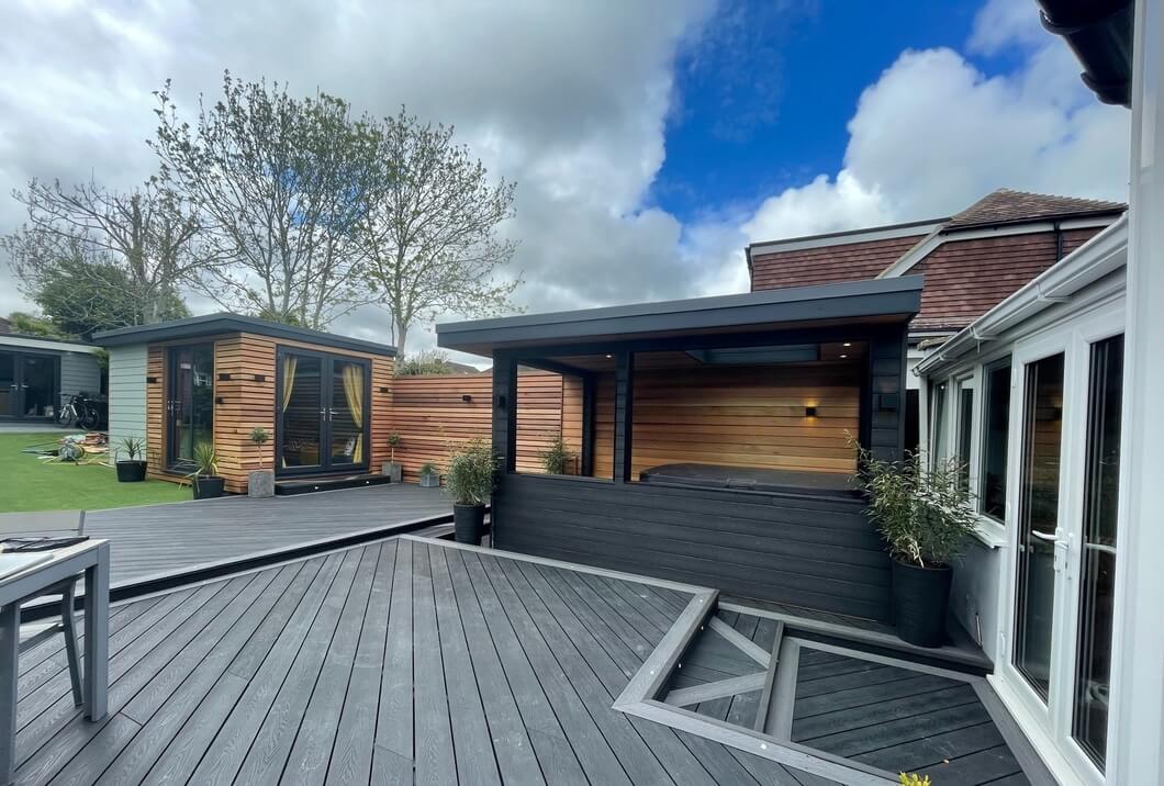 Exterior of hot tub house clad with Cladco Charcoal Composite Woodgrain Decking Boards, creating a cohesive design across decking and building facades