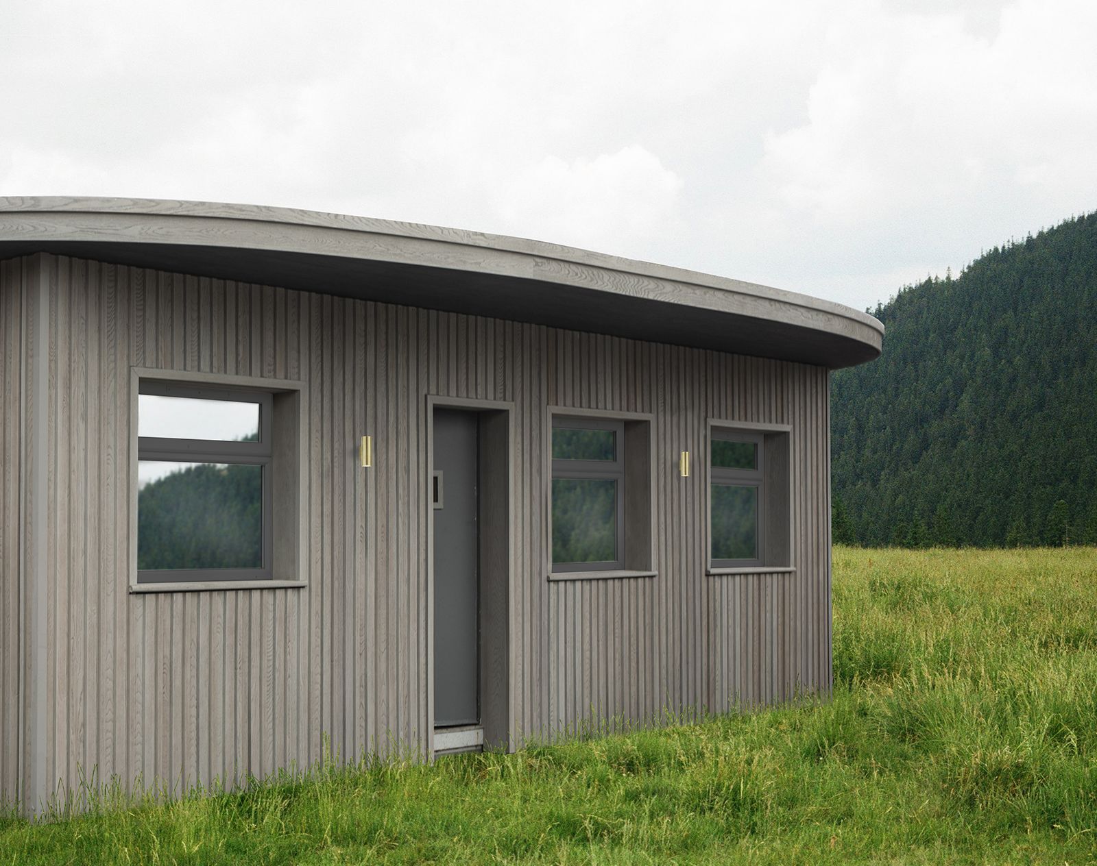 Modern building clad in vertical grey Millboard cladding, featuring a curved roof and surrounded by open countryside and forested hills.