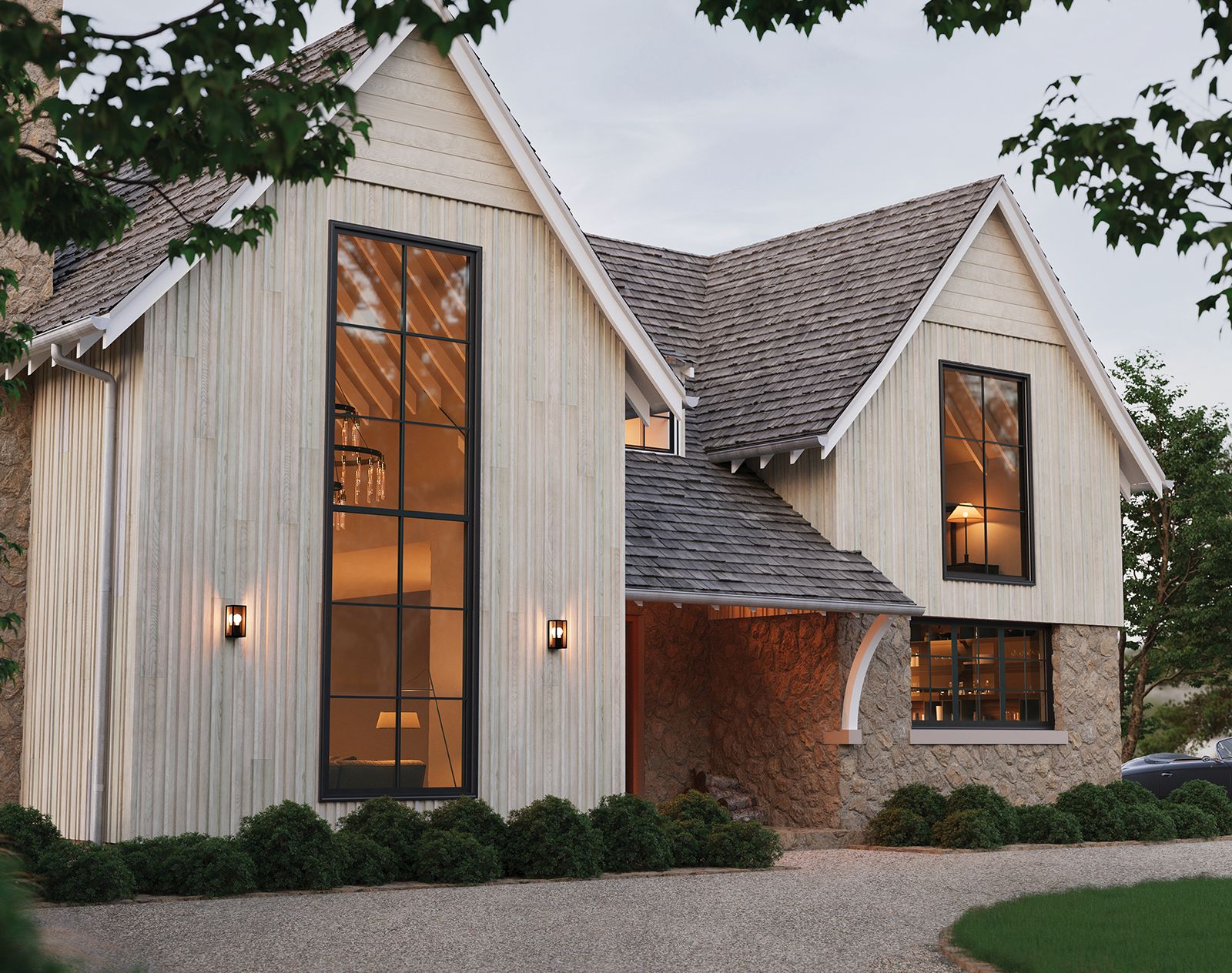 Contemporary house with light-coloured vertical Millboard cladding and stone base, featuring large black-framed windows and pitched roofs.