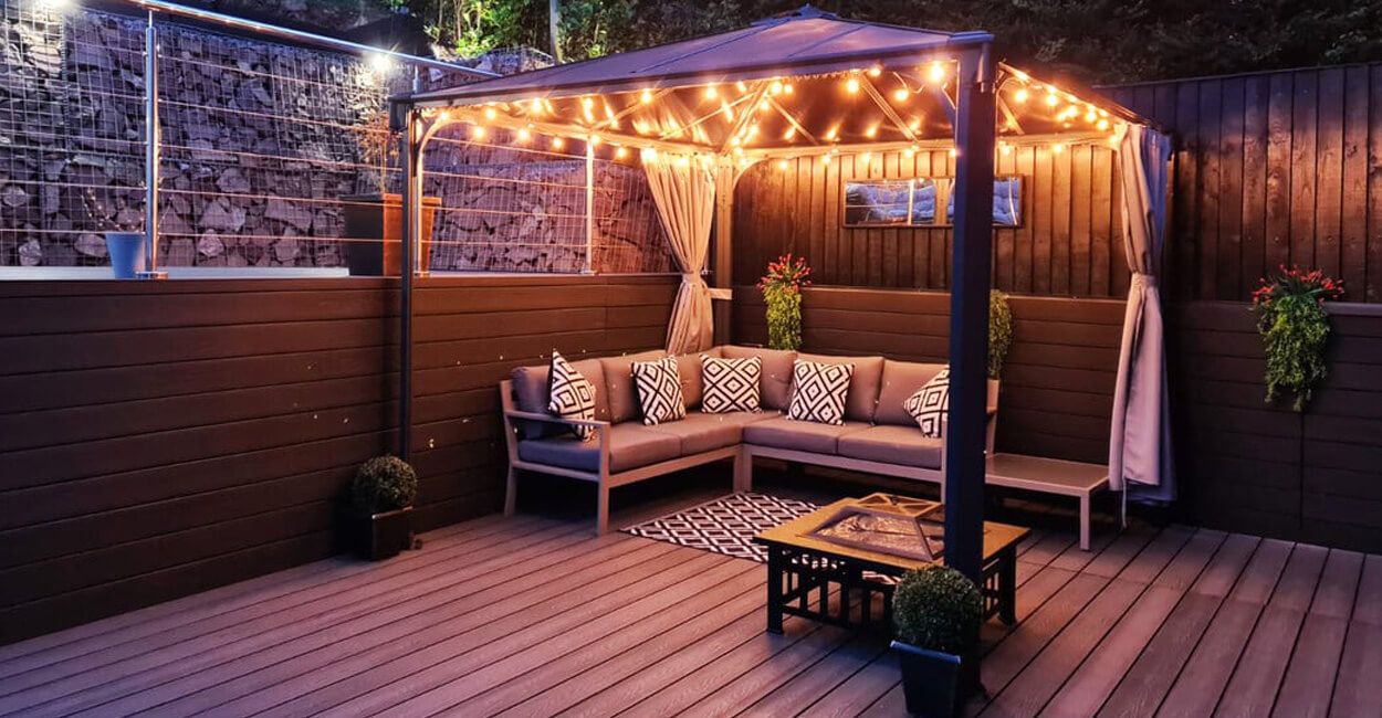 Garden decking area at night with warm lighting