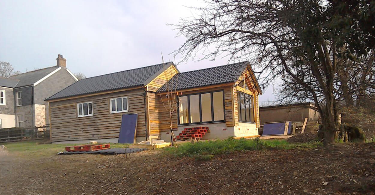 Side view of barn conversion featuring Cladco Tile Form Roofing Sheets and timber cladding