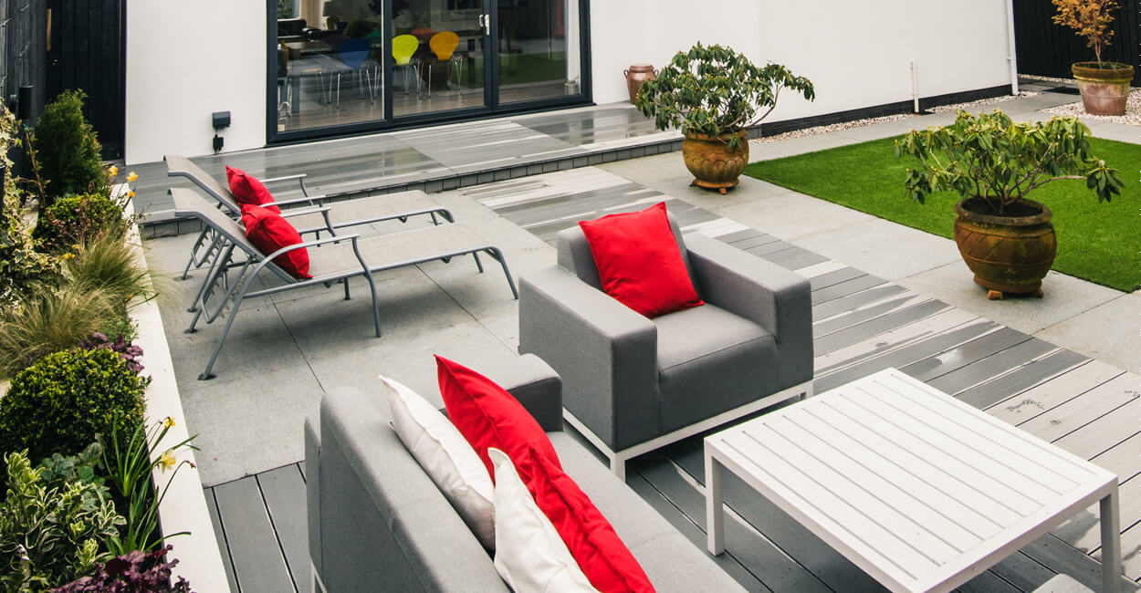 Large sliding doors connecting the airy interior to the outdoor composite decking area in the Penarth retirement home.