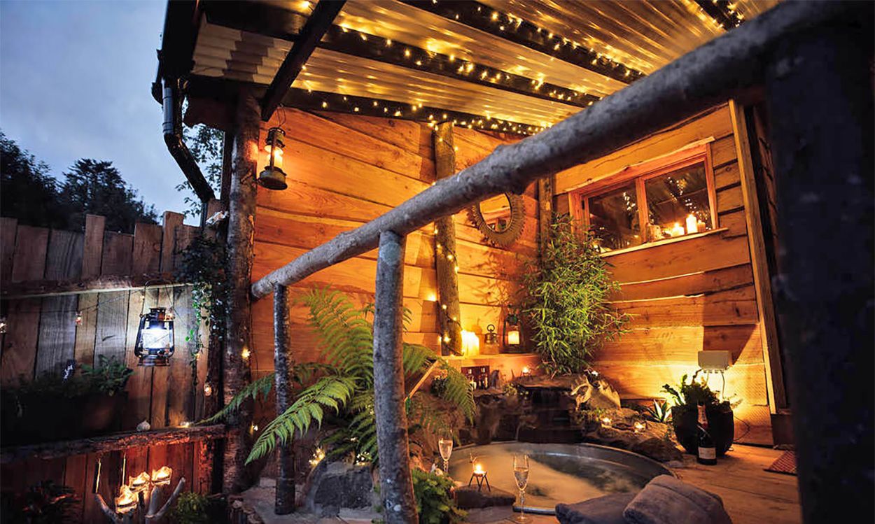 Balcony of Ursa Bear Cabin featuring built-in waterfall tin bathtub and Cladco corrugated steel roofing overhead