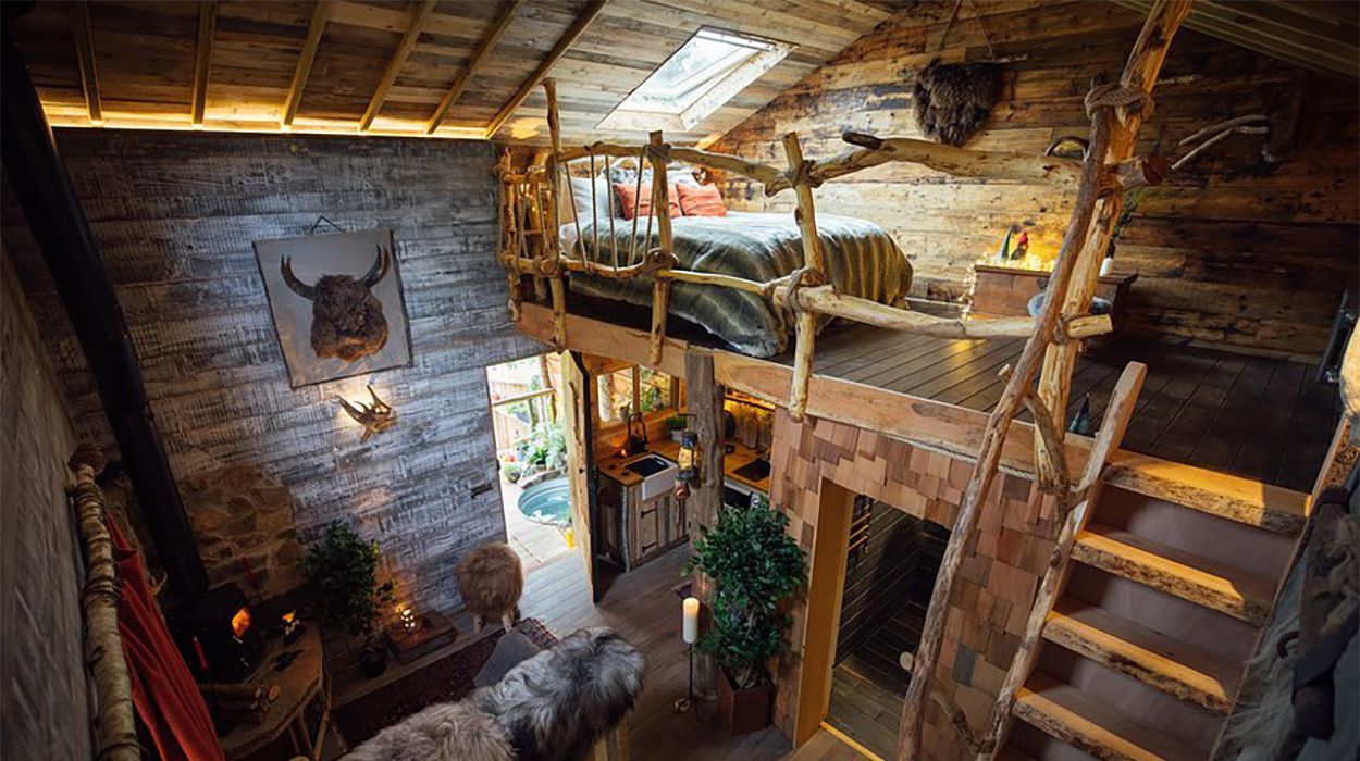Interior of Ursa Bear Cabin showcasing wood burner and rustic timber finishes by With Bear Hands UK