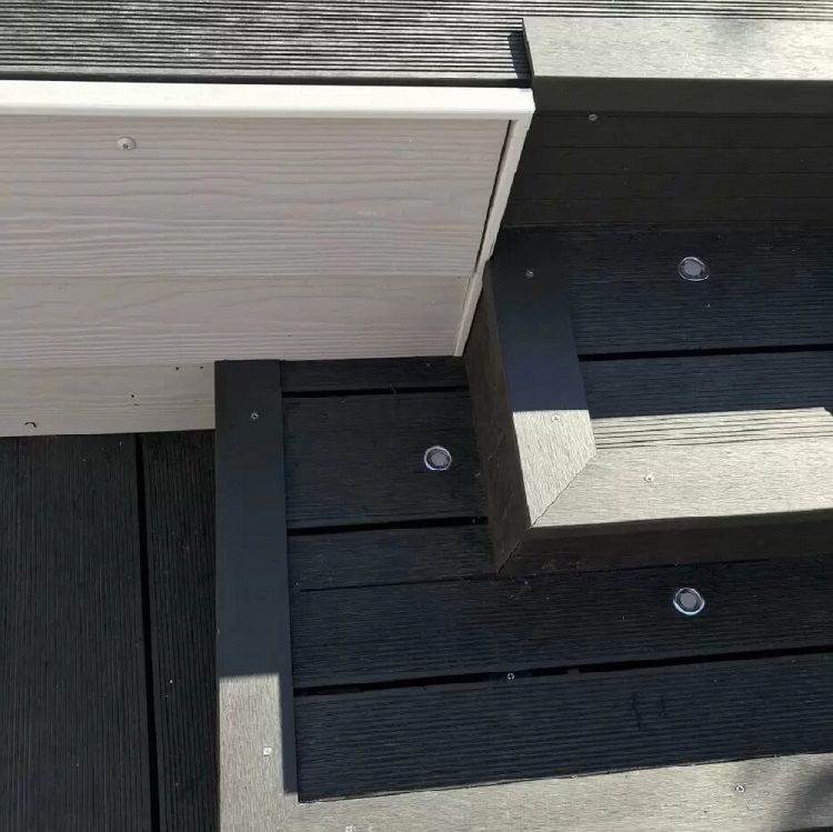 Completed steps featuring charcoal composite decking with corner trims and integrated lighting