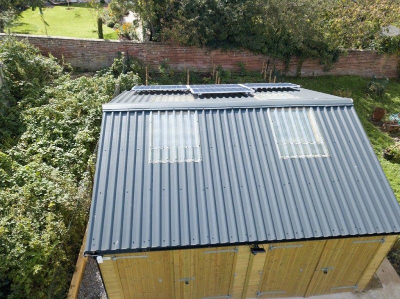 Bespoke timber garage built by Shields Buildings featuring Cladco black corrugated steel roofing in North Tawton, Devon