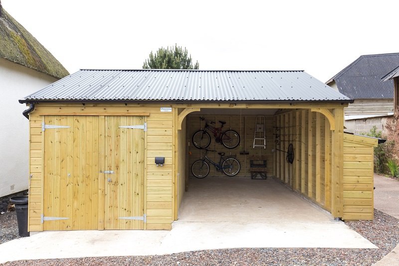 Custom timber carport by Shields Buildings with Cladco black corrugated steel roofing in North Tawton, Devon