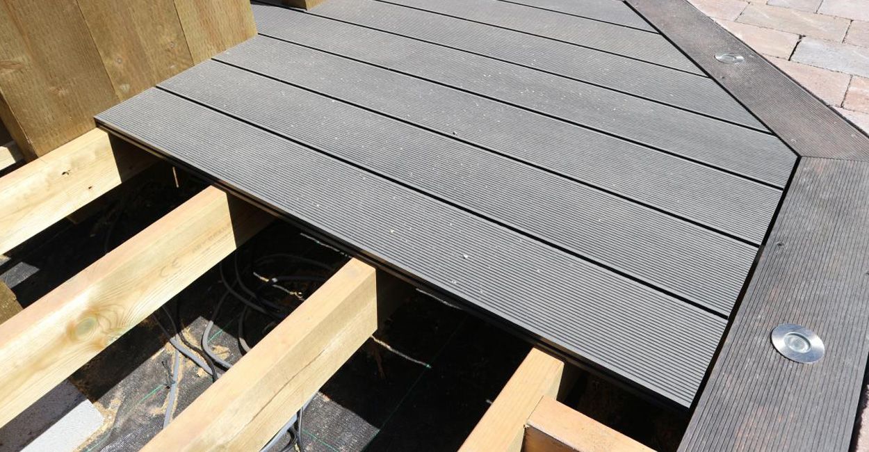 Detail of Cladco composite decking boards complemented by timber railings and built-in benches in the Fountain Inn's beer garden.