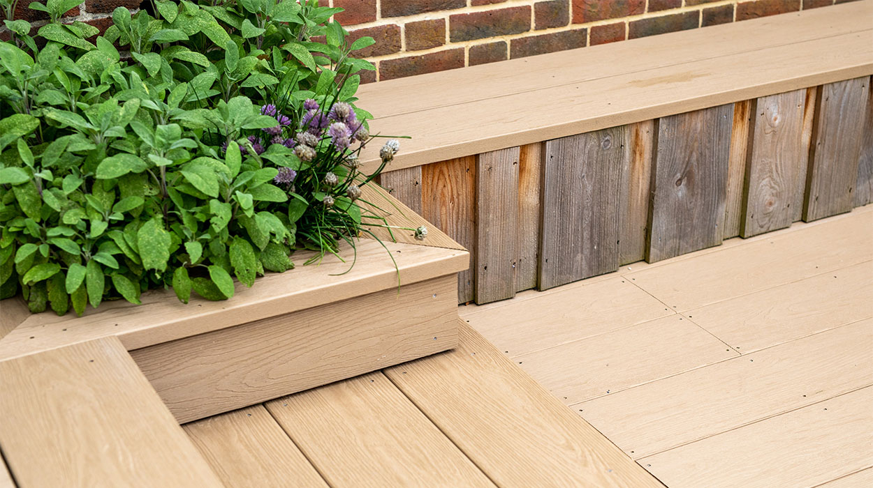 Plant bed and steps constructed with Cladco Cedar Wood PVC decking at Oakwood West Holidays