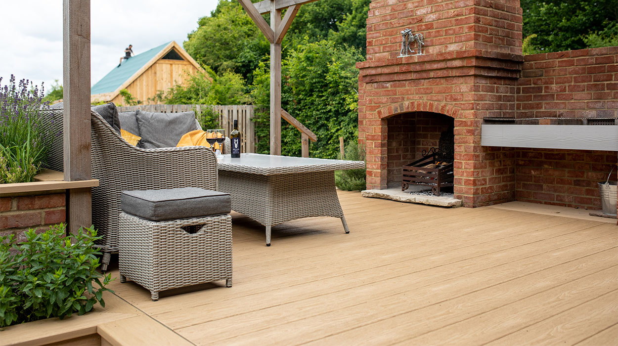Outdoor BBQ area under timber veranda featuring Cladco Cedar Wood PVC decking at Oakwood West Holidays