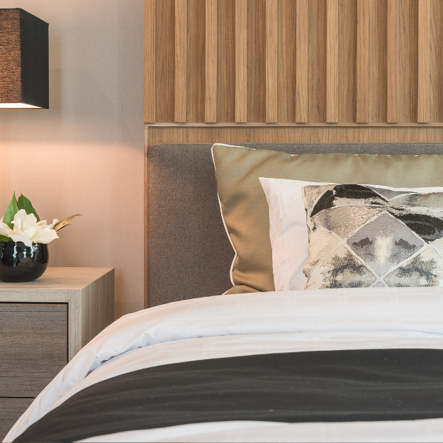 Board and batten wall panelling installed as a headboard in a modern bedroom Board and batten wall panelling installed as a headboard in a modern bedroom