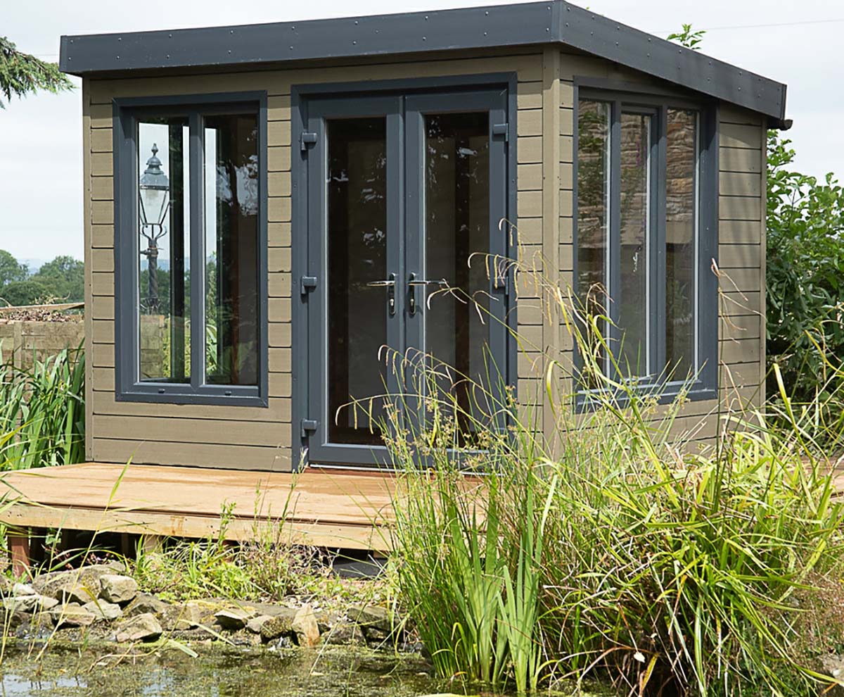 A lakeside outdoor room Clad with Olive Green Composite Wall Cladding which in with the natural surroundings.