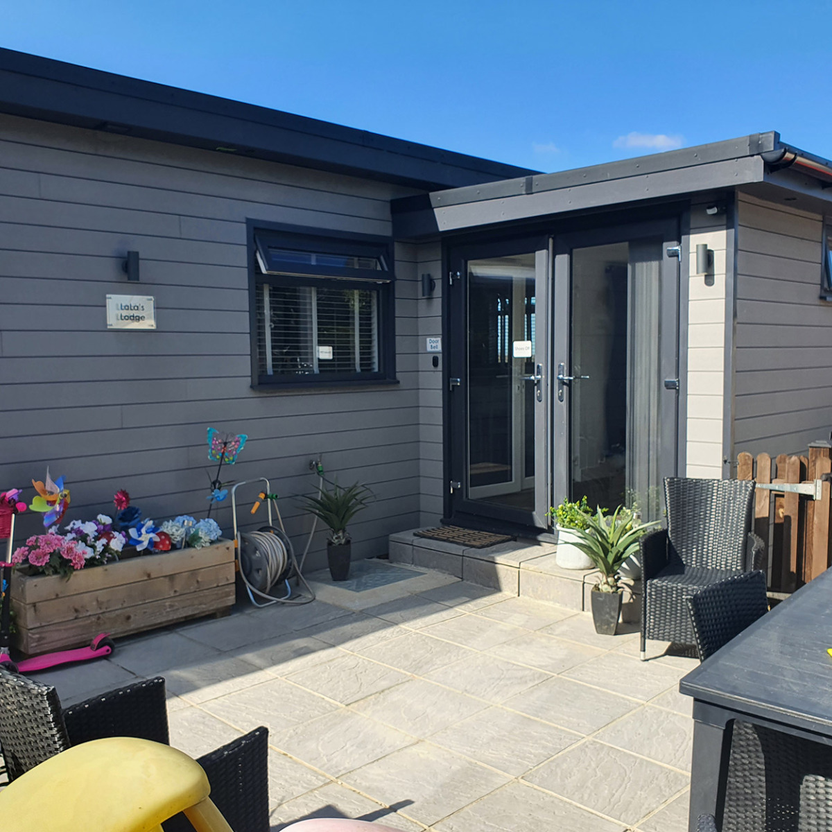 Light Grey Composite Wall Cladding Boards fitted horizontally across a garden courtyard building.
