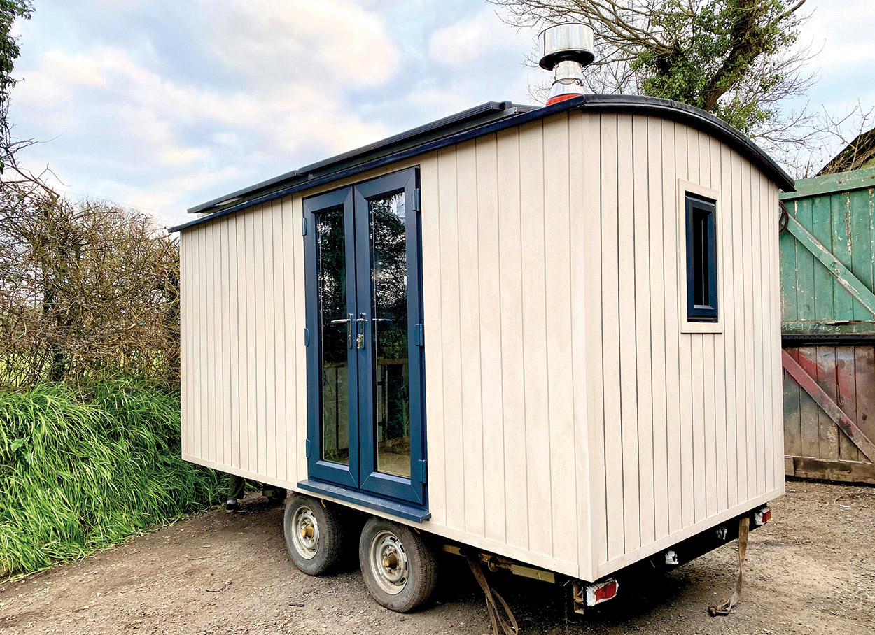 Ivory Composite Wall Cladding Boards fitted vertically on a unique portable shephards hut.