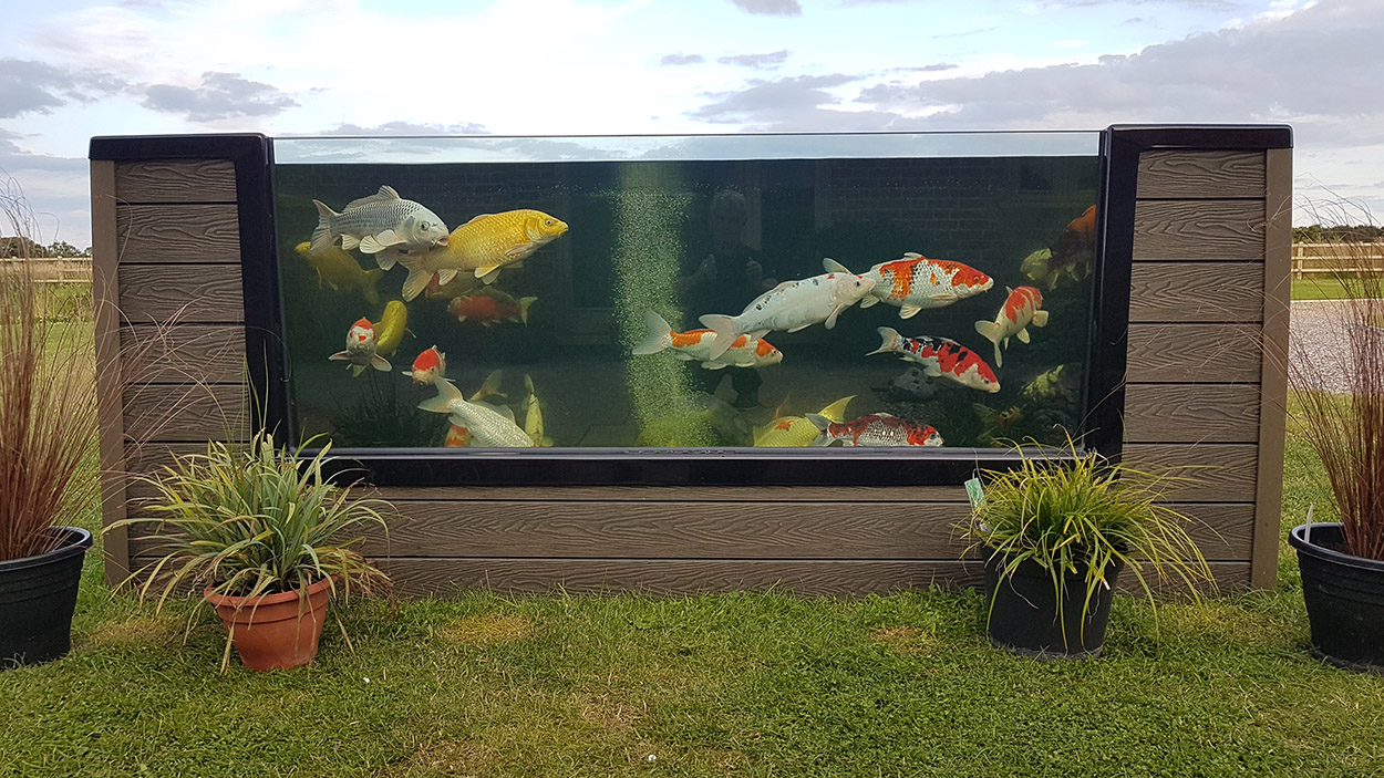 A koi fish pond has been finished on the exterior with Composite Wall Cladding for a unique garden project.