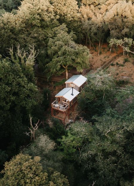 Cove Valley cabin featuring Cladco corrugated steel roofing and cladding with a timber balcony overlooking the Exe Valley