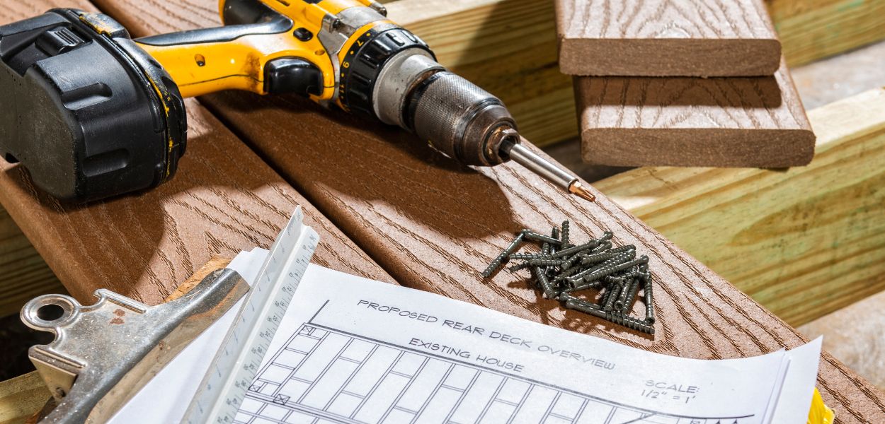 Tools and screws on decking boards