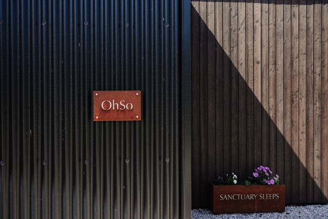 Black Corrugated Sheeting with decorative plaque and planter.