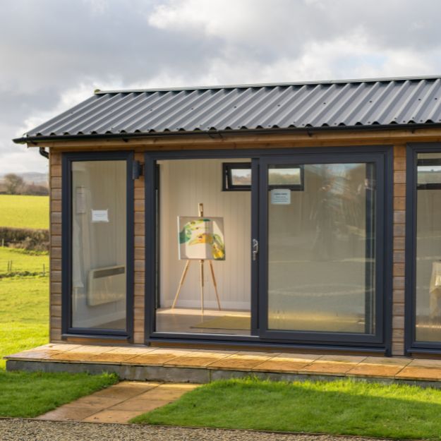 Custom-built combination studio by Shields Buildings, highlighting timber cladding and Cladco's steel roofing solution.